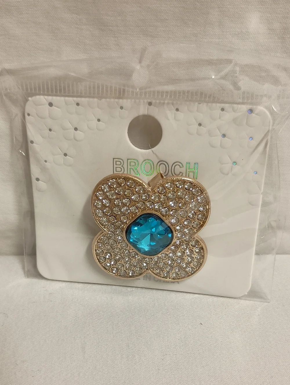 Gold Tone Rhinestone Flower Brooch Pin with Iridescent Crystal Center Blue